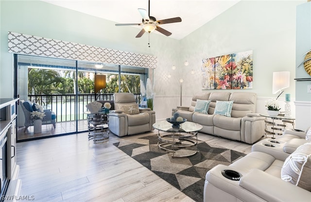 living room featuring ceiling fan and light hardwood / wood-style flooring