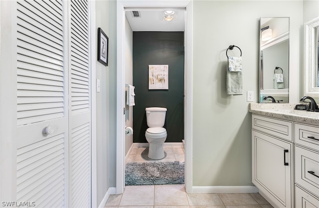 bathroom featuring tile patterned floors, vanity, and toilet