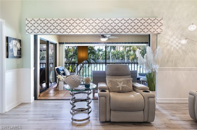 sitting room featuring ceiling fan and light wood-type flooring