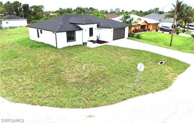 view of front facade featuring a garage and a front lawn