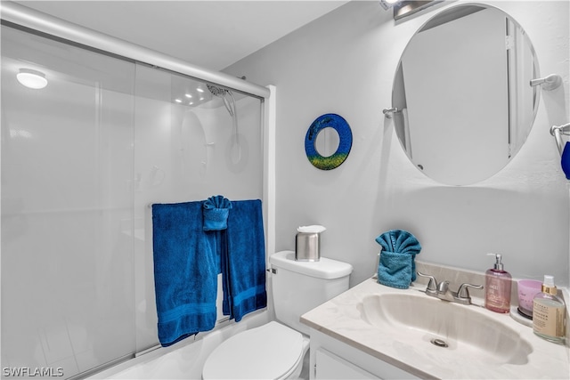 full bathroom featuring vanity, enclosed tub / shower combo, and toilet