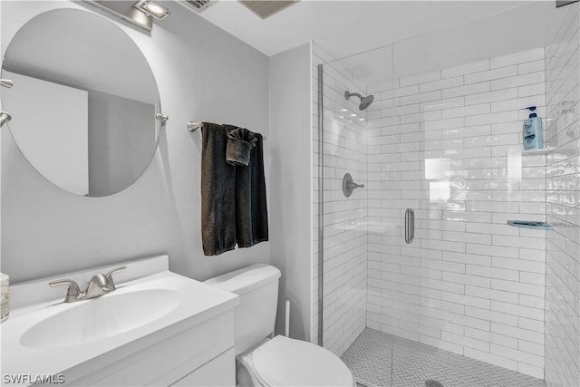 bathroom featuring vanity, toilet, and an enclosed shower