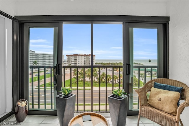 sunroom featuring a water view