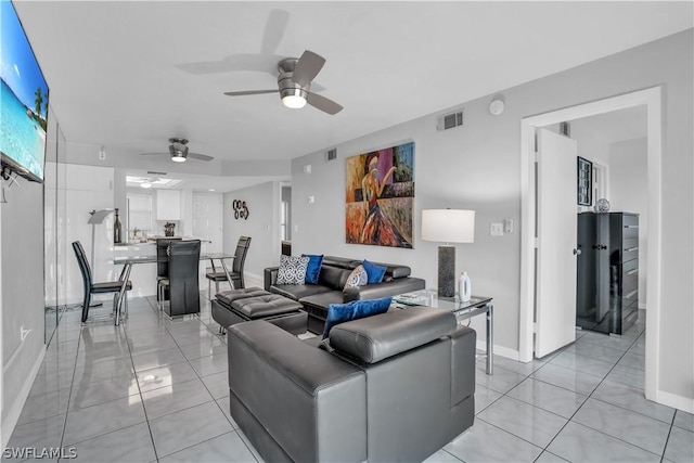 tiled living room with ceiling fan