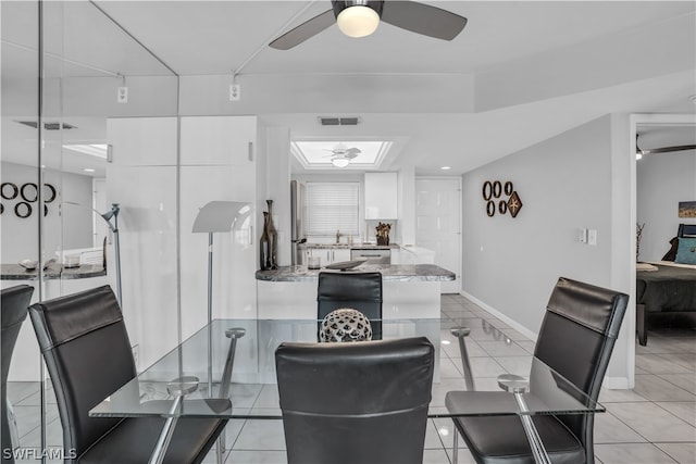 tiled dining area with sink and ceiling fan