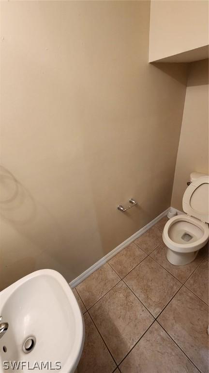 bathroom featuring tile patterned flooring and toilet