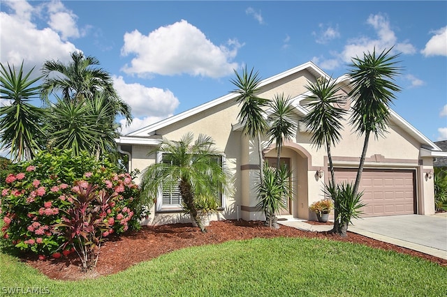 view of front of house featuring a garage and a front lawn