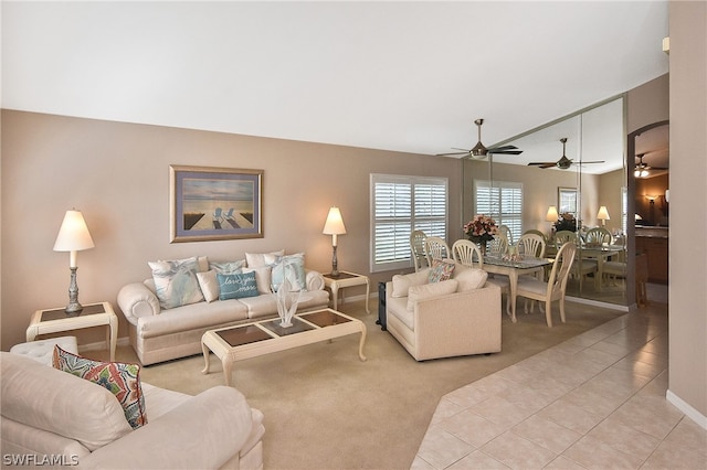 living room with ceiling fan and light tile patterned floors