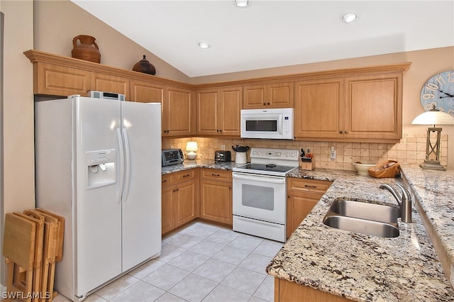 kitchen featuring white appliances, sink, light tile patterned floors, decorative backsplash, and lofted ceiling