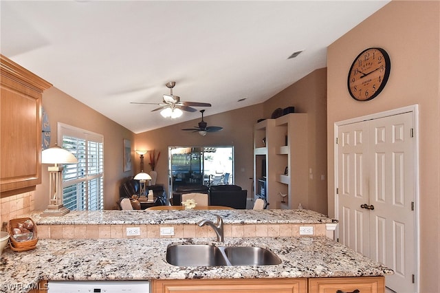 kitchen featuring sink, light brown cabinets, lofted ceiling, dishwasher, and ceiling fan