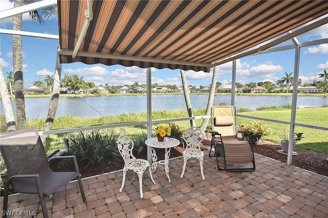 sunroom / solarium featuring a water view