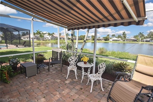 sunroom featuring a water view