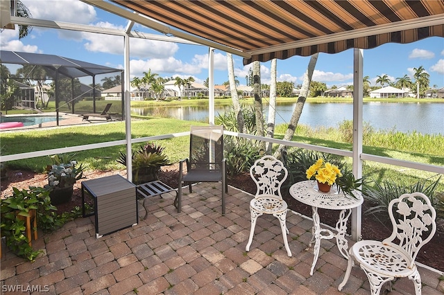 sunroom featuring a water view