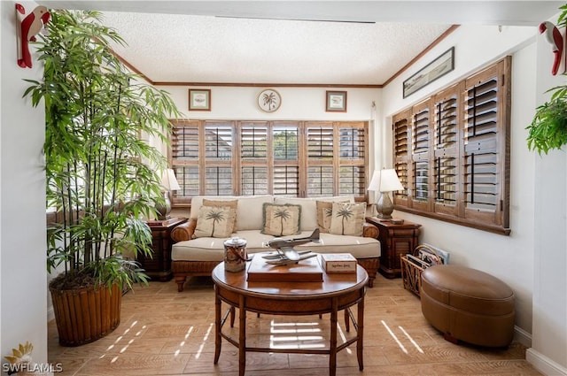 sitting room with hardwood / wood-style flooring, ornamental molding, and a textured ceiling