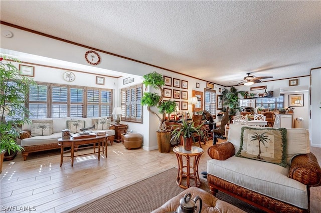 living room featuring a textured ceiling and ceiling fan