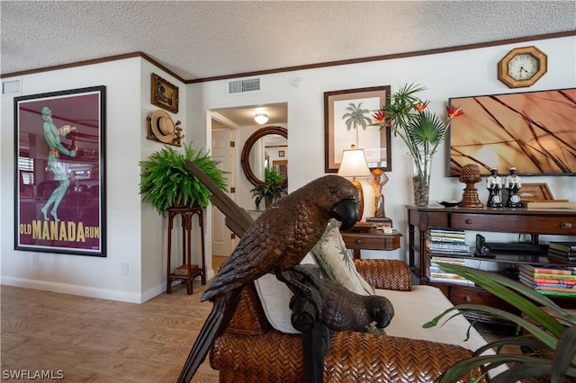 living area with ornamental molding and a textured ceiling