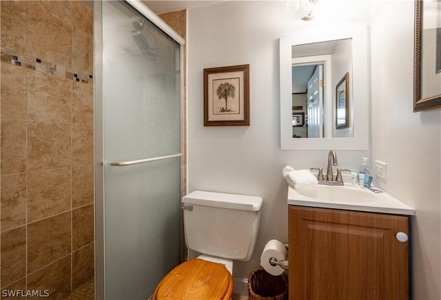 bathroom with vanity, toilet, and walk in shower