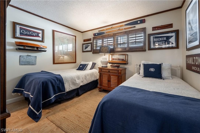 bedroom with a textured ceiling and light wood-type flooring