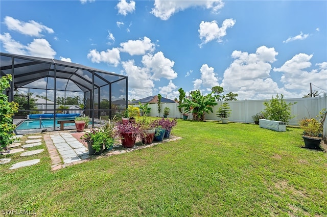 view of yard featuring a covered pool and glass enclosure