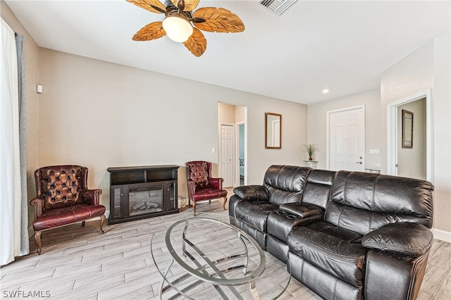 living room with ceiling fan and light hardwood / wood-style floors