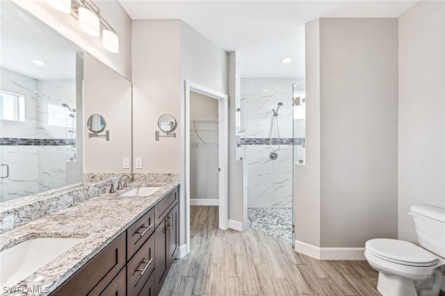 bathroom with an enclosed shower, vanity, and toilet