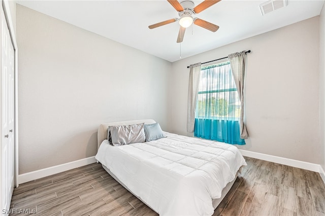 bedroom with ceiling fan and light wood-type flooring