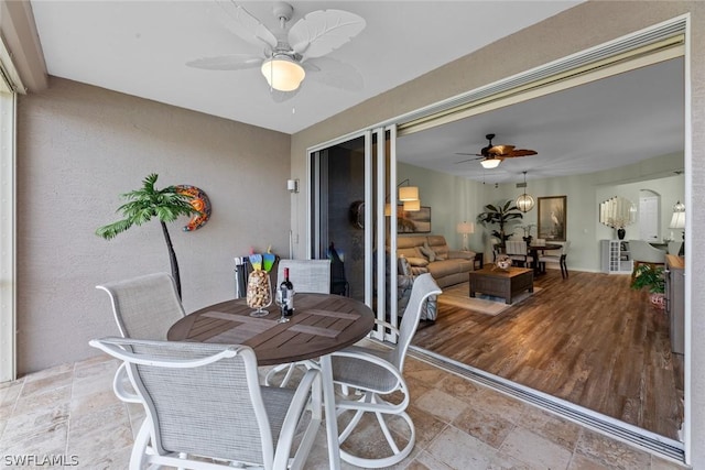 sunroom featuring ceiling fan