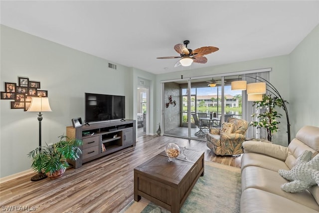 living room featuring ceiling fan and wood-type flooring