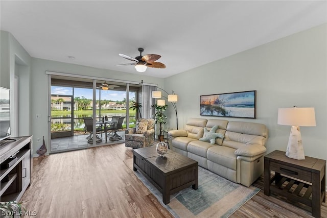 living room with ceiling fan and wood-type flooring