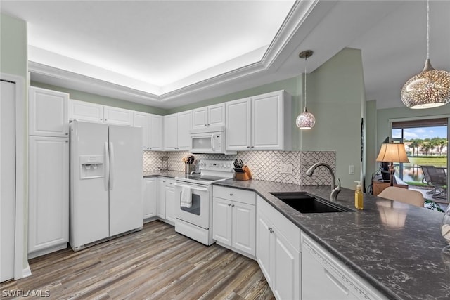 kitchen featuring white appliances, decorative light fixtures, white cabinetry, and sink