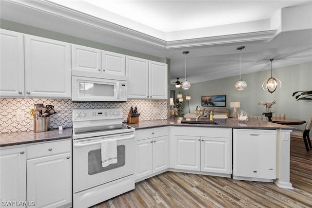 kitchen with white cabinetry, sink, hanging light fixtures, kitchen peninsula, and white appliances