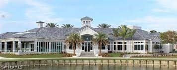 back of house with a yard and a water view