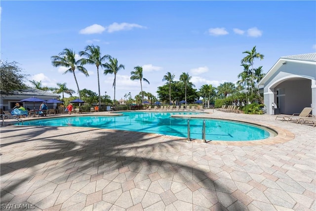 view of pool featuring a patio area and a hot tub