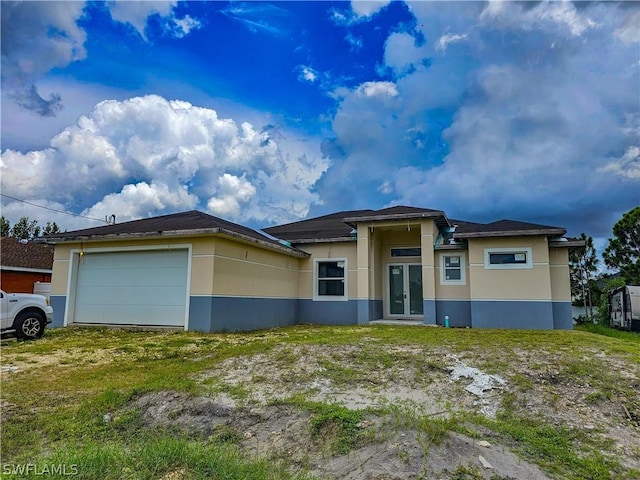 4111 22nd St SW, Lehigh Acres, FL 33976 - view of front facade featuring stucco siding, french doors, and a garage
