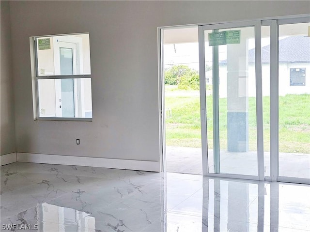 4111 22nd St SW, Lehigh Acres, FL 33976 - doorway to outside featuring marble tiled flooring and baseboards