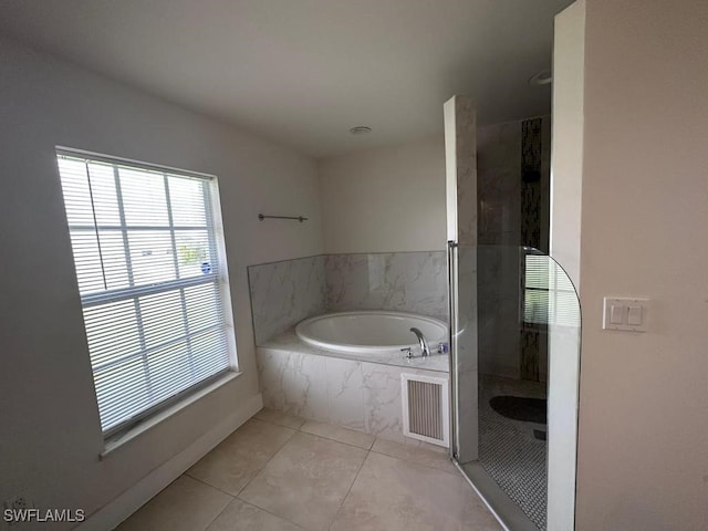 bathroom with tile patterned flooring and separate shower and tub