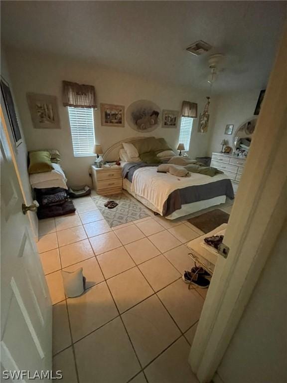 bedroom with ceiling fan and light tile patterned flooring