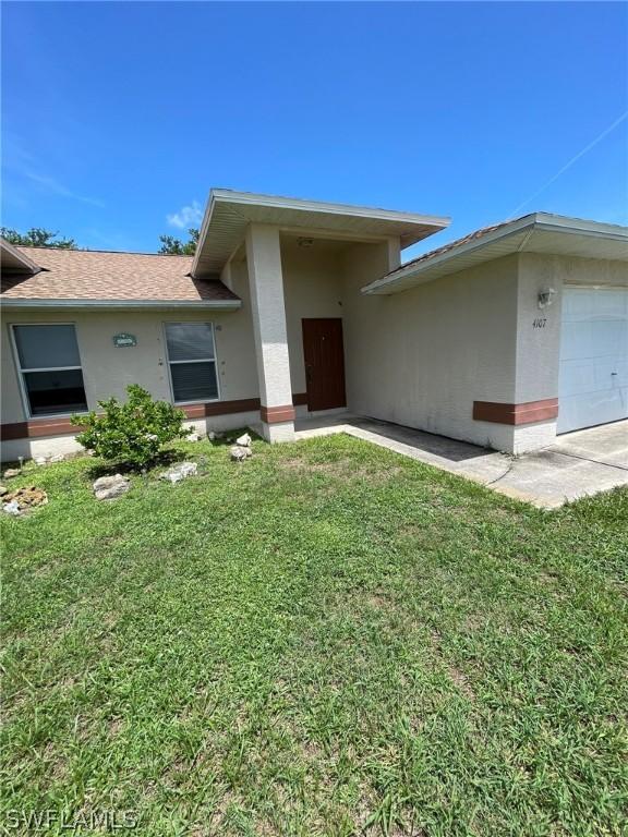 view of front facade with a front lawn and a garage