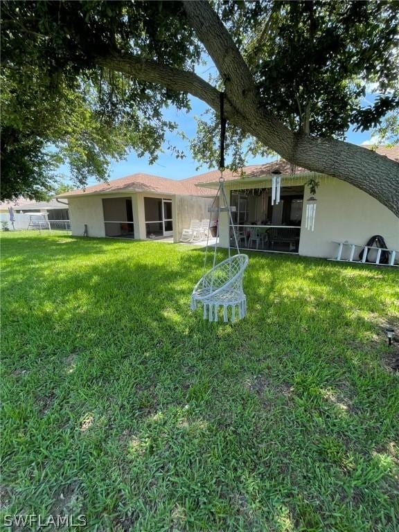 rear view of property featuring a yard