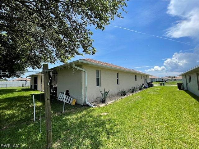 view of property exterior with a lawn