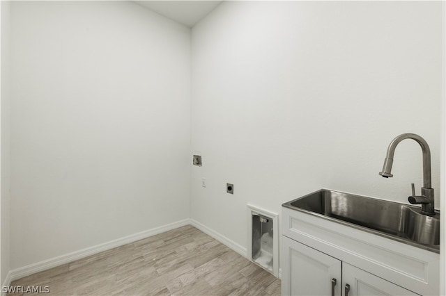 laundry room with cabinets, sink, light hardwood / wood-style flooring, and hookup for an electric dryer