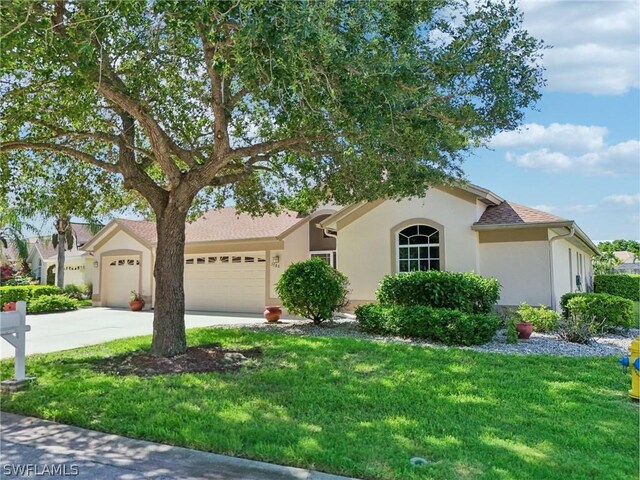 single story home with a garage and a front yard