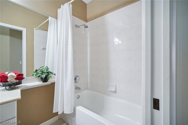 bathroom featuring shower / bathtub combination with curtain and vanity