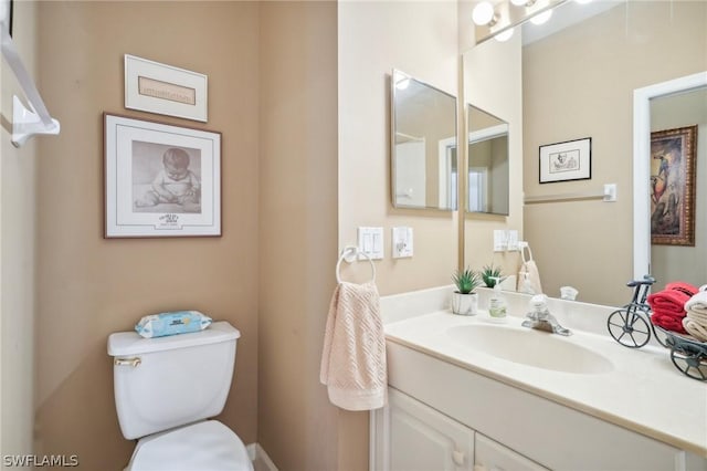 bathroom featuring vanity and toilet