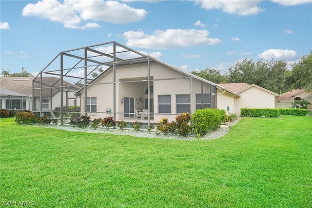 rear view of property with a yard and glass enclosure