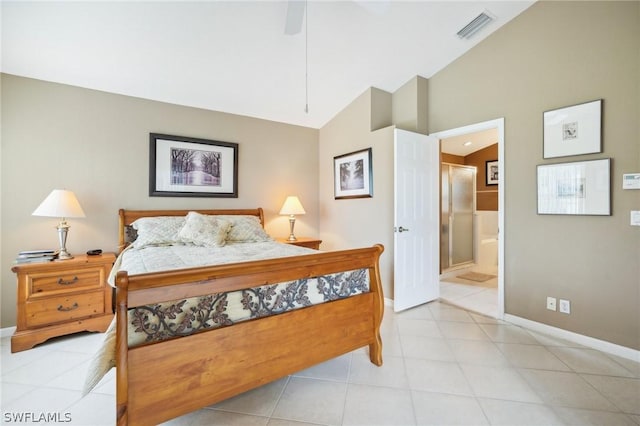 tiled bedroom with vaulted ceiling, ceiling fan, and ensuite bathroom