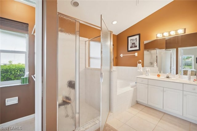 bathroom featuring plus walk in shower, lofted ceiling, tile patterned floors, and vanity