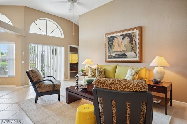 living room with high vaulted ceiling, ceiling fan, and light tile patterned flooring