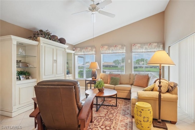 interior space featuring ceiling fan, lofted ceiling, and light tile patterned floors