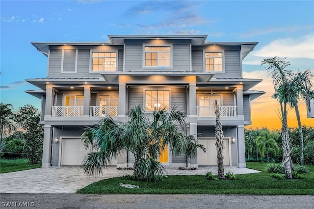 view of front of property with a balcony and a garage